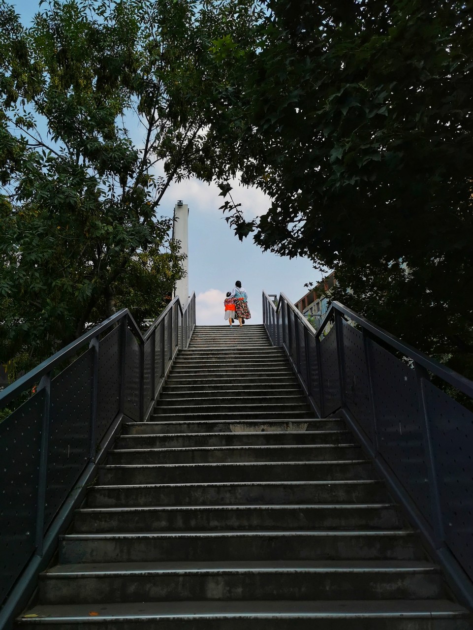 A steep Chongqing stairway passing through a lived-in neighborhood