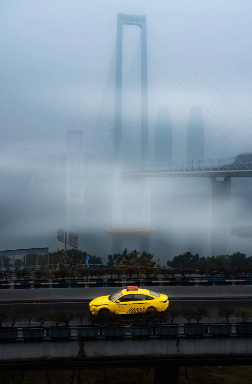 A Chongqing bridge appearing through morning fog