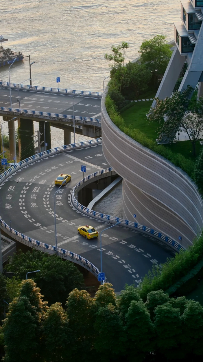 Layered riverside roads winding through Chongqing